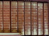a lot of books that are on a shelf