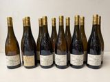 several bottles of wine are lined up on a table