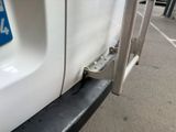 a close up of a white truck with a number plate on it