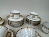 a lot of plates and cups on the table