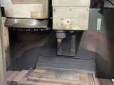 a machine that is working on a piece of wood