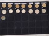 a lot of coins that are in a black case