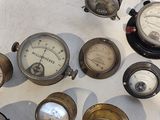 many different types of gauges displayed on a table