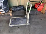 a small metal platform with a broom and a mop on it
