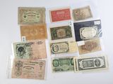 several different types of paper money are displayed on a white surface