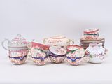 many different types of teapots and saucers on the table