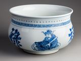a blue and white bowl with a man riding a horse on it