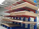 a large stack of shelves in a warehouse filled with lots of wood