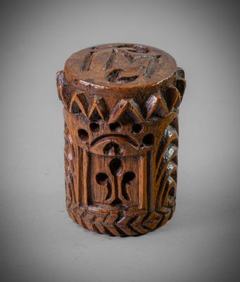 a close up of a wooden object with carvings on it