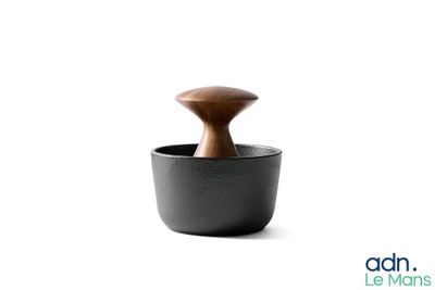 a black cup with a wooden handle on a white background