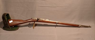 an old rifle with a wooden barrel and a green case