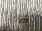 a label that says tradition removed on a piece of fabric
