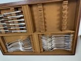 many forks and spoons in a box on the table