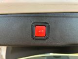 a close up of a red button on a car ' s dashboard