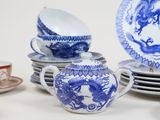 several blue and white dishes and cups and saucers on a table