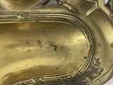 an antique brass clock with a clock face on a white background