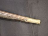 a baseball bat that is laying on a black cloth