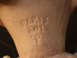 a close up of a teddy bear with a tag on it ' s back