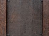 an old wooden picture frame with a small hole in the middle