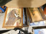 many pictures of horses on display on a table