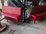 a red booth with two chairs and a table in front of it
