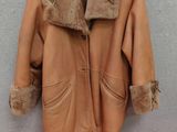 brown leather jacket hanging on a wall next to a red carpet