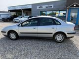 a silver car that is parked in front of a building