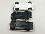 three toy cars sitting next to each other on a table