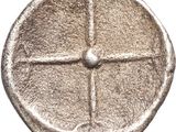a silver coin with a cross on it on a white background