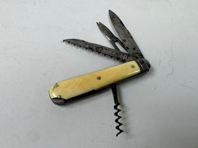 a swiss army knife with a yellow handle on a white surface