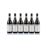 four bottles of red wine lined up on a white surface