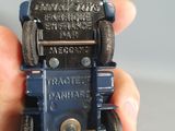 a person holding a small toy car in their hand
