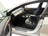 a car with its door open and the driver ' s seat down
