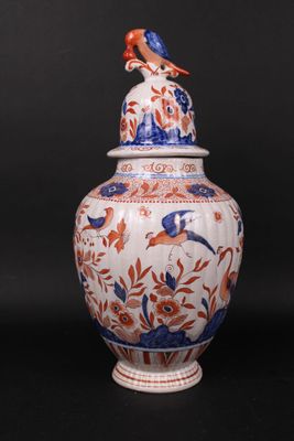 an image of a vase with a bird sitting on top of it