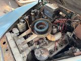 an old car engine with the hood open