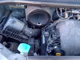 a close up of a car ' s engine with its hood open