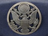 navy officer ' s hat with eagle emblem on top of it