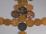 a cross made out of coins on a table