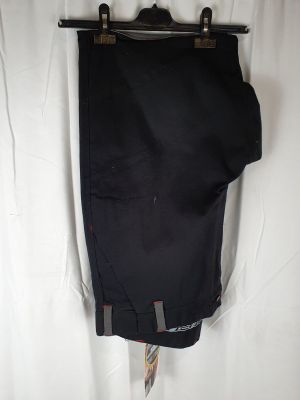 the back of a pair of black pants hanging on a wall