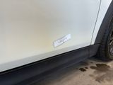 a sticker on the side of a white car