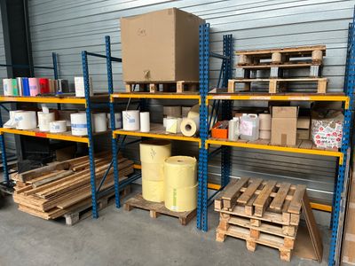 many pallets with boxes and boxes on them in a warehouse
