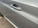 a silver car with a hole in the side of it