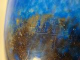 a picture of a blue vase with a sky background