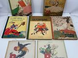 six children ' s books are lined up on a white surface