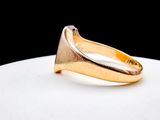 an image of a gold ring on a white plate