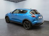 the rear end of a blue nissan juke suv parked in a garage