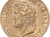 a close up of a gold coin with a man ' s head on it