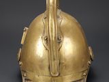 an antique brass helmet with an elephant ' s head on the front