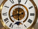 a gold clock with roman numerals on it
