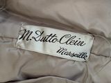 a close up of a label on a beige jacket
